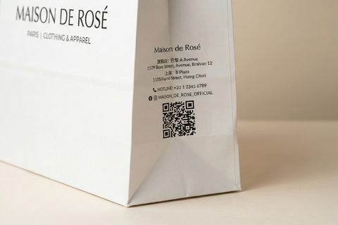 Chi tiết in thông tin cửa hàng và mã QR Code sắc nét trên mặt hông khi in túi giấy shop.