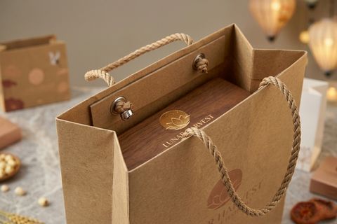 Hệ thống nẹp miệng và khuy mắt cáo kim loại gia cường khi in túi giấy bánh trung thu chịu tải trọng lớn cho các set quà tặng doanh nghiệp.