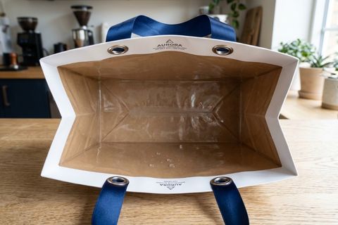 Hệ thống quai xách ruy băng sang trọng và cấu trúc lòng túi tráng PE của túi giấy không thấm nước.